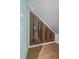 Unique attic space with slatted wood accent wall, a glass partition, and hardwood floors at 2430 Ames St, Edgewater, CO 80214