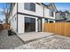 Exterior of the home showcasing a concrete patio and a wooden fence at 2430 Ames St, Edgewater, CO 80214