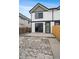 Exterior of the home showcasing a concrete patio and a wooden fence at 2430 Ames St, Edgewater, CO 80214