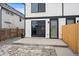 Exterior of the home showcasing a concrete patio and a wooden fence at 2430 Ames St, Edgewater, CO 80214