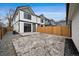 Exterior of the home showcasing a concrete patio and a wooden fence at 2430 Ames St, Edgewater, CO 80214