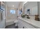 Modern bathroom featuring sleek fixtures, white vanity with a dark sink, and a shower/tub combo at 2430 Ames St, Edgewater, CO 80214