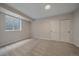 This bedroom features neutral carpet, a large window with a blind, and double closets at 2430 Ames St, Edgewater, CO 80214