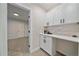 Convenient butler's pantry with white cabinets, counter space, and view into another room at 2430 Ames St, Edgewater, CO 80214