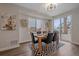 Sunlit dining room features a modern table setting, stylish rug, and large windows for ample natural light at 2430 Ames St, Edgewater, CO 80214