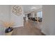 Stylish entryway leading to an open-concept kitchen and dining area, showcasing modern decor and wood flooring at 2430 Ames St, Edgewater, CO 80214