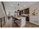 Open-concept kitchen with a large island, stainless steel appliances, and modern finishes for entertaining guests at 2430 Ames St, Edgewater, CO 80214
