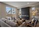 Cozy living room showcasing a modern fireplace, comfortable seating, and a sliding glass door to the exterior at 2430 Ames St, Edgewater, CO 80214