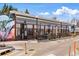 Exterior shot of a store/restaurant featuring an art mural and a row of windows at 2430 Ames St, Edgewater, CO 80214