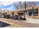 Storefront of Bottles & Bitters at Sloan's Lake with a liquor sign and parked motorcycle at 2430 Ames St, Edgewater, CO 80214