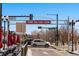 Street view featuring cars passing under a 'Thank You - Call Again' sign on a sunny day at 2430 Ames St, Edgewater, CO 80214
