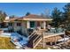 Stunning backyard with a large deck, glass railings, outdoor furniture, and patio, offering a relaxing outdoor living space at 93 Glenmoor Dr, Englewood, CO 80113