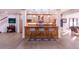 Entertainer's bar boasts pendant lighting, wood cabinetry, and seating for three at 93 Glenmoor Dr, Englewood, CO 80113