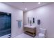 Bathroom with teal shower, white tile flooring, and a light wood vanity at 93 Glenmoor Dr, Englewood, CO 80113