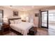 Calm bedroom with white bedding, wood nightstands, and a decorative gray rug at 93 Glenmoor Dr, Englewood, CO 80113