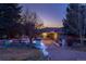 Stunning single Gathering home with brick driveway and tile roof at dusk at 93 Glenmoor Dr, Englewood, CO 80113