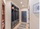 Hallway with dark wood accents, built-in storage and drawers, and a neutral-toned rug at 93 Glenmoor Dr, Englewood, CO 80113