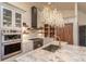 Bright kitchen with stainless steel appliances, chandeliers, and sink at 93 Glenmoor Dr, Englewood, CO 80113