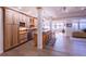 Kitchen with wood cabinets, a center island with seating, and wood floors throughout at 93 Glenmoor Dr, Englewood, CO 80113
