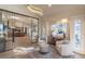 Bright living room with chairs, windows, and a chandelier at 93 Glenmoor Dr, Englewood, CO 80113