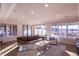 Sunlit living room with large windows, a leather sofa, and light colored wood floors at 93 Glenmoor Dr, Englewood, CO 80113