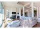 Bright living room featuring hardwood floors, a stone fireplace, large windows, and comfortable seating at 93 Glenmoor Dr, Englewood, CO 80113
