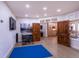 Spacious living room with wood floors, tv, workout area and access to kitchen at 93 Glenmoor Dr, Englewood, CO 80113
