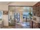 Open-concept living room featuring sliding glass doors with mountain views, hardwood floors, and stylish furniture at 93 Glenmoor Dr, Englewood, CO 80113