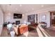 Bright living room with a fireplace, leather sofa, and light colored wood floors at 93 Glenmoor Dr, Englewood, CO 80113