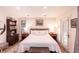 Comfortable main bedroom with plush bedding, soft lighting and french doors to patio at 93 Glenmoor Dr, Englewood, CO 80113
