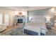 Serene main bedroom featuring a stone fireplace, hardwood floors, a seating area, and large windows at 93 Glenmoor Dr, Englewood, CO 80113