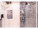 Modern shower featuring decorative tile, glass door, and a rainfall shower head at 93 Glenmoor Dr, Englewood, CO 80113