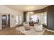 Sitting room with hardwood floors, chandelier, two chairs, an ottoman, and large bay window at 93 Glenmoor Dr, Englewood, CO 80113