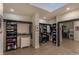 Spacious walk-in closet with custom shelving, drawers, and mirrored door leading to the washer and dryer at 93 Glenmoor Dr, Englewood, CO 80113