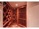 Rustic wine cellar with custom wood racks for ample bottle storage and display shelving at 93 Glenmoor Dr, Englewood, CO 80113