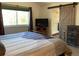 Bedroom with ensuite bath, tv and attractive barn door entrance at 6585 W 84Th Way # 109, Arvada, CO 80003