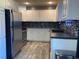 Well-equipped kitchen with stainless steel appliances and a modern backsplash at 6585 W 84Th Way # 109, Arvada, CO 80003