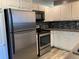 Modern kitchen features stainless steel appliances and ample cabinet space at 6585 W 84Th Way # 109, Arvada, CO 80003