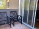 Outdoor patio with two chairs and sliding glass doors at 6585 W 84Th Way # 109, Arvada, CO 80003