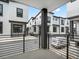 Exterior view from balcony of modern townhomes with black trim and shared spaces at 2046 S Holly St # 1, Denver, CO 80222