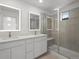 Sleek bathroom featuring double sinks and a glass-enclosed shower at 2046 S Holly St # 1, Denver, CO 80222