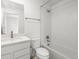 Bright bathroom featuring a white vanity and a shower-tub combo at 2046 S Holly St # 1, Denver, CO 80222