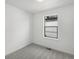 Empty bedroom with neutral carpet, white walls, and a single window offering natural light at 2046 S Holly St # 1, Denver, CO 80222