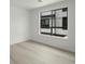 Well-lit bedroom with hardwood floors and a large window overlooking the exterior at 2046 S Holly St # 1, Denver, CO 80222
