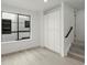 Bright bedroom featuring hardwood floors, a built-in storage cabinet, and a large window at 2046 S Holly St # 1, Denver, CO 80222