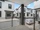 Modern townhomes with a monochromatic color scheme, black trim, and private outdoor spaces at 2046 S Holly St # 1, Denver, CO 80222