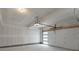 Unfinished garage space with drywall and a garage door with windows at 2046 S Holly St # 1, Denver, CO 80222