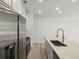 Bright kitchen has a stainless steel refrigerator, a stainless steel faucet and quartz countertops at 2046 S Holly St # 1, Denver, CO 80222