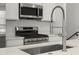 Updated Kitchen with stainless steel appliances, quartz countertops, and a stylish faucet at 2046 S Holly St # 1, Denver, CO 80222
