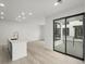 Bright living space with sliding doors to outdoor balcony and modern fixtures at 2046 S Holly St # 1, Denver, CO 80222